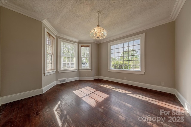 spare room featuring hardwood / wood-style floors, visible vents, crown molding, baseboards, and a notable chandelier