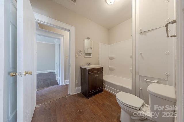 bathroom featuring wood finished floors, vanity, and toilet