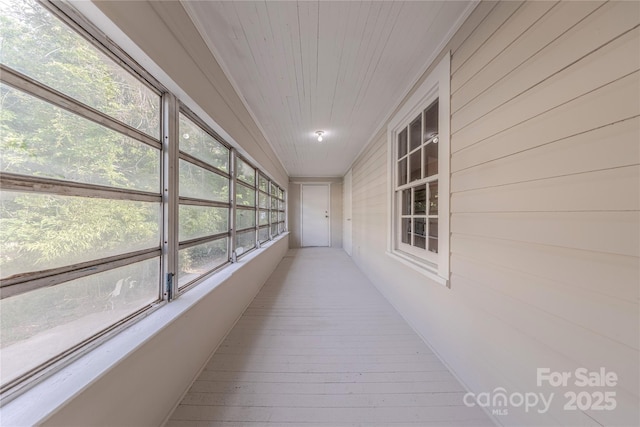 corridor featuring wood ceiling, wood-type flooring, and wooden walls