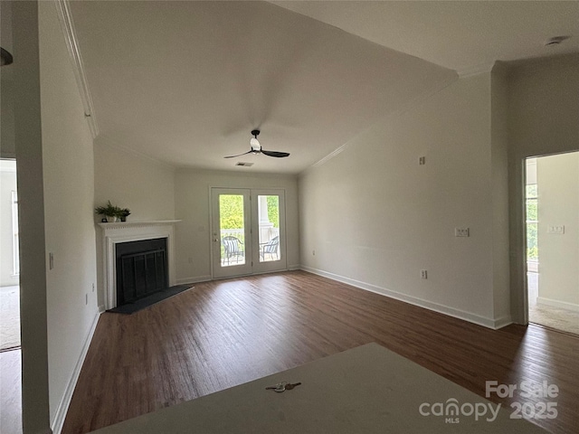 unfurnished living room with a fireplace with flush hearth, baseboards, ceiling fan, and wood finished floors
