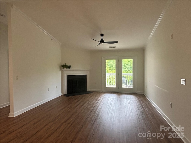 unfurnished living room with crown molding, dark wood-style flooring, a ceiling fan, a fireplace with flush hearth, and visible vents