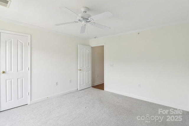 9027 Mcdowell Creek Ln, Cornelius, NC 28031 - unfurnished bedroom featuring ceiling fan, visible vents, carpet floors, baseboards, and ornamental molding