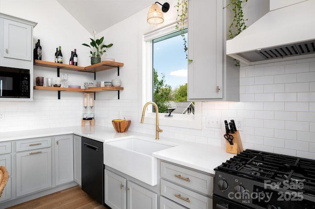103 Pennsylvania Ave, Asheville, NC 28806 - kitchen featuring under cabinet range hood, black appliances, a sink, decorative backsplash, and vaulted ceiling