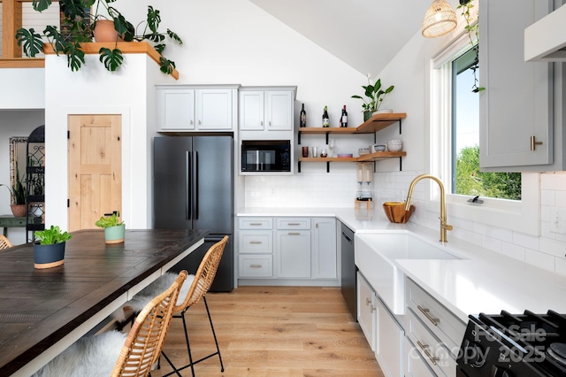 103 Pennsylvania Ave, Asheville, NC 28806 - kitchen featuring black appliances, exhaust hood, lofted ceiling, light wood finished floors, and tasteful backsplash
