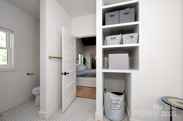 103 Pennsylvania Ave, Asheville, NC 28806 - bathroom featuring baseboards, toilet, and ensuite bath