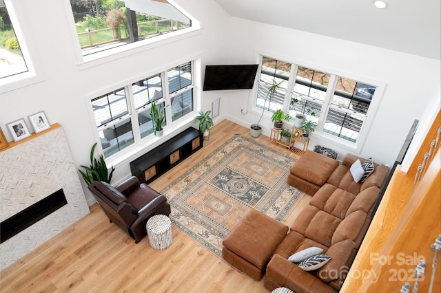 103 Pennsylvania Ave, Asheville, NC 28806 - living room featuring a stone fireplace, wood finished floors, baseboards, a towering ceiling, and recessed lighting