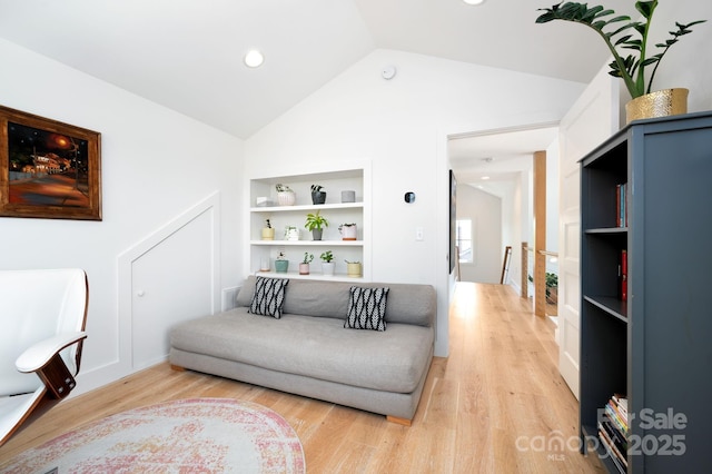 103 Pennsylvania Ave, Asheville, NC 28806 - living room with built in shelves, vaulted ceiling, and light wood-style floors