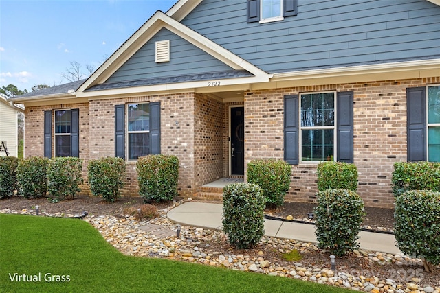view of front of home featuring brick siding