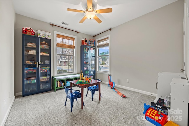 recreation room featuring visible vents, baseboards, carpet, and ceiling fan