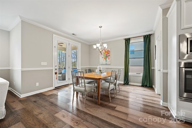dining room featuring wood-type flooring, a chandelier, and crown molding