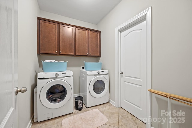 laundry area featuring cabinet space, washing machine and dryer, baseboards, and light tile patterned floors