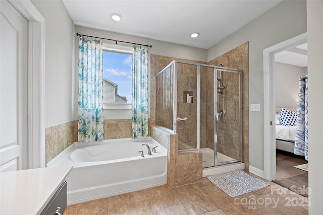 ensuite bathroom with a shower stall, a garden tub, vanity, and recessed lighting