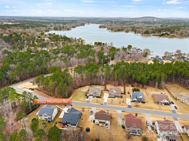 bird's eye view with a water view and a residential view