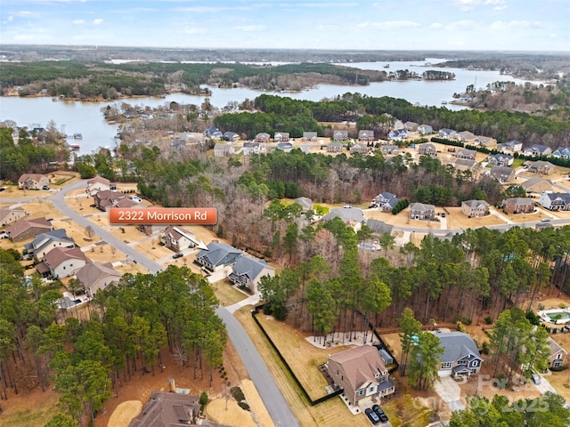drone / aerial view with a residential view and a water view
