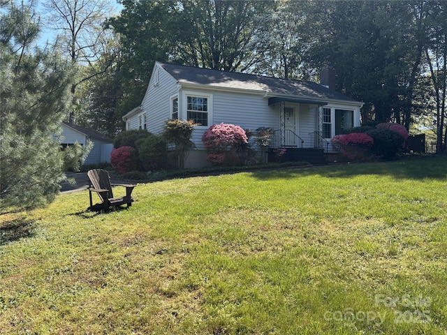 single story home with a front lawn and a chimney