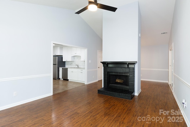 1455 Fieldcrest Cir, Rock Hill, SC 29732 - unfurnished living room featuring a sink, dark wood finished floors, visible vents, ceiling fan, and a fireplace