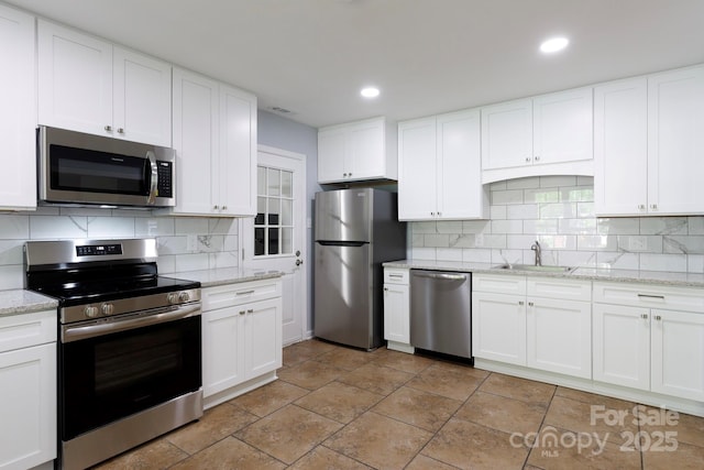 1455 Fieldcrest Cir, Rock Hill, SC 29732 - kitchen with a sink, decorative backsplash, white cabinetry, appliances with stainless steel finishes, and recessed lighting