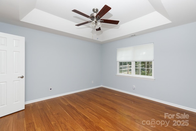 1455 Fieldcrest Cir, Rock Hill, SC 29732 - empty room featuring baseboards, a ceiling fan, wood finished floors, and a raised ceiling