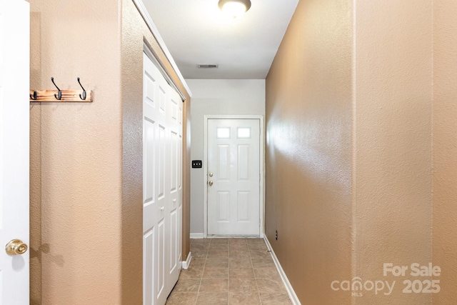 entryway with baseboards and visible vents