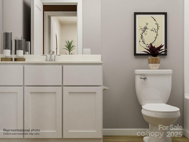 2107 Columbidae Ln, Gastonia, NC 28052 - bathroom with baseboards, wood finished floors, toilet, and vanity