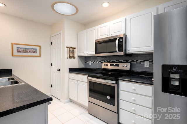 206 Carrington Pl, Arden, NC 28704 - kitchen with light tile patterned floors, recessed lighting, appliances with stainless steel finishes, and white cabinetry