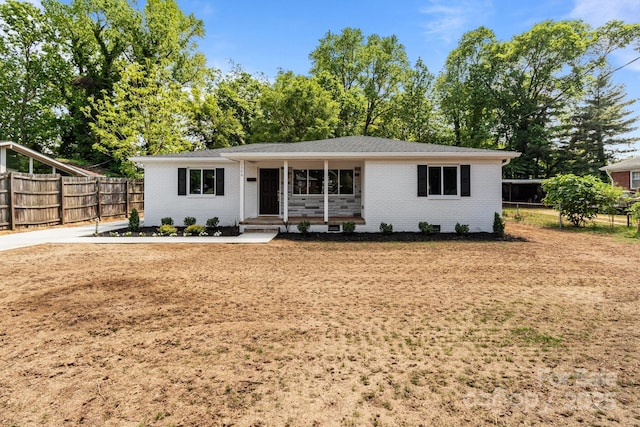 ranch-style home with brick siding and fence