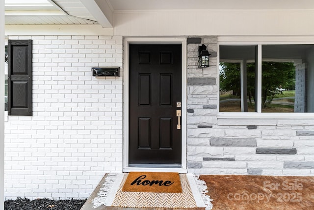 entrance to property with brick siding