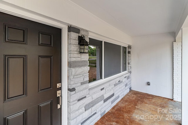 view of exterior entry featuring stone siding