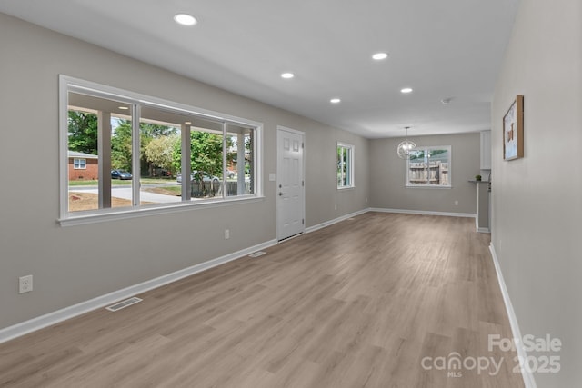 interior space featuring an inviting chandelier, visible vents, baseboards, light wood-style floors, and recessed lighting