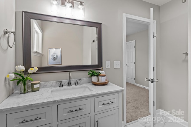 bathroom with vanity and baseboards