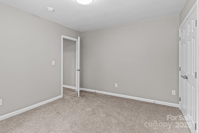 unfurnished bedroom featuring baseboards and carpet