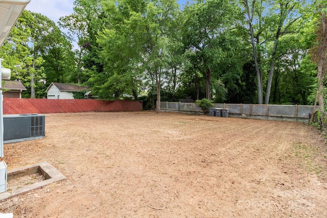 view of yard featuring fence and cooling unit
