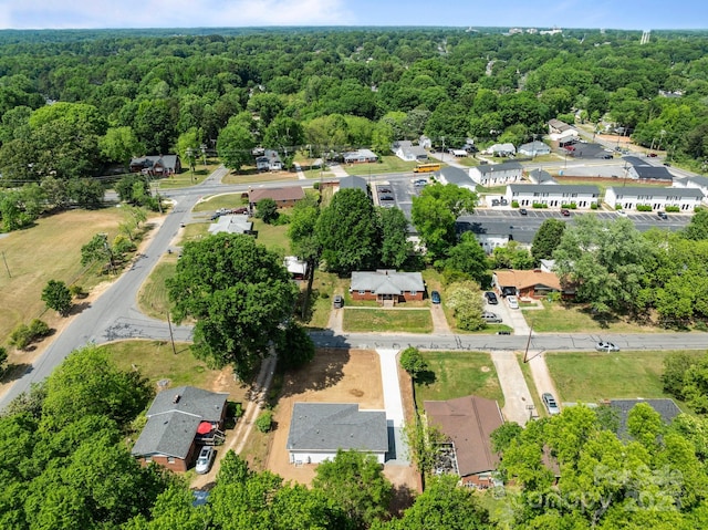 birds eye view of property featuring a view of trees