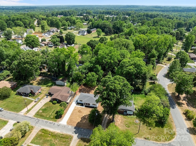 birds eye view of property with a view of trees and a residential view