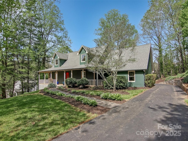 cape cod house with driveway, a shingled roof, a front lawn, and covered porch