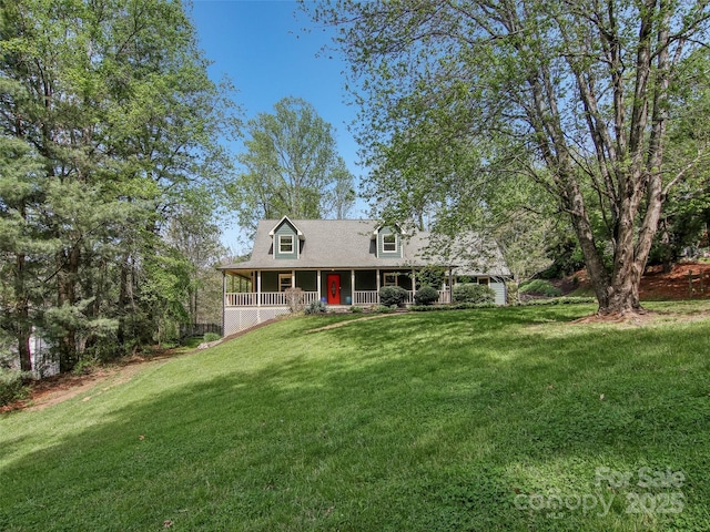 cape cod home with covered porch and a front yard