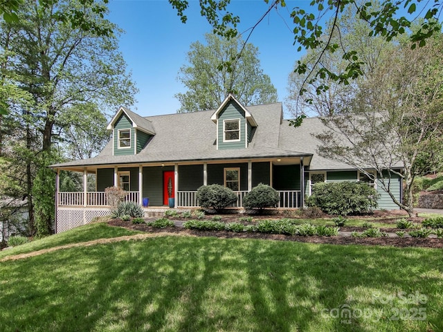 new england style home featuring a front lawn, roof with shingles, and a porch