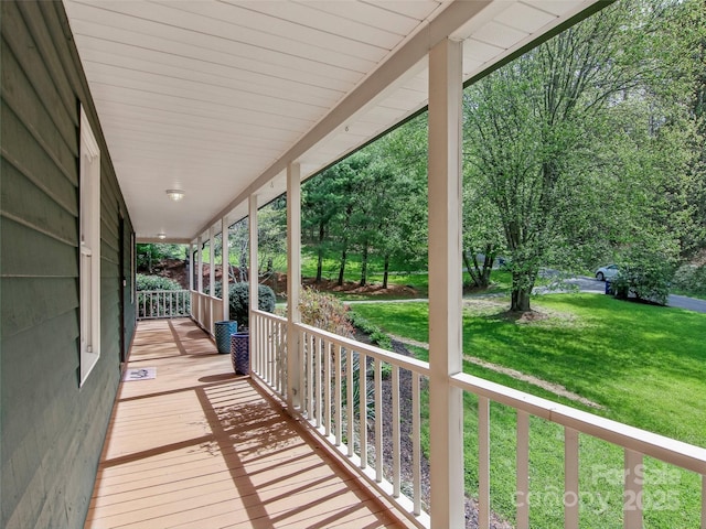 deck with a yard and covered porch