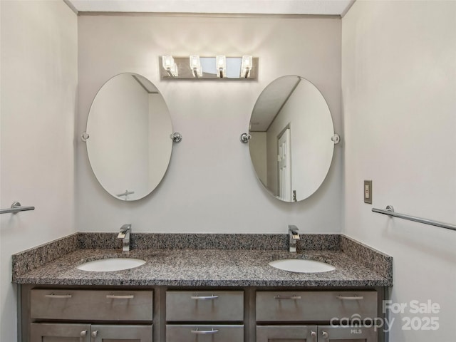 full bathroom featuring double vanity and a sink