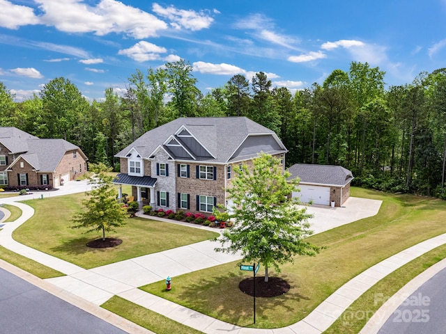 colonial-style house featuring brick siding, a front lawn, an attached garage, and concrete driveway