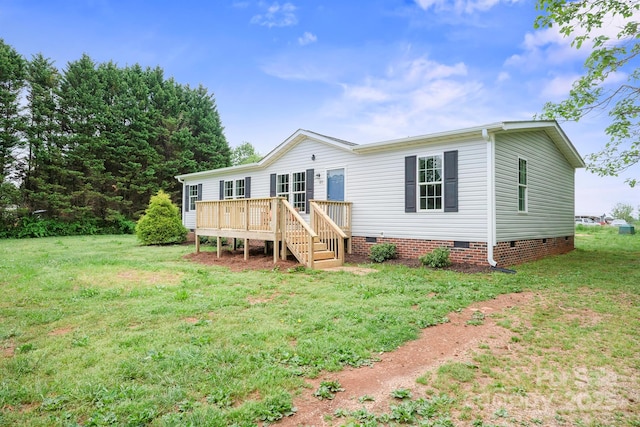 manufactured / mobile home featuring a deck, a front lawn, and crawl space