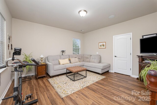 living area with wood finished floors and baseboards