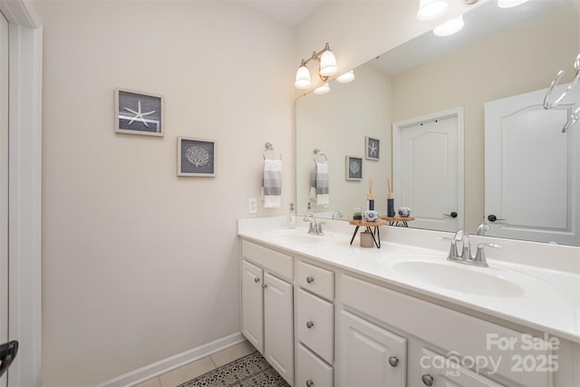 full bathroom with tile patterned floors, baseboards, a sink, and double vanity