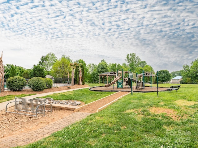 community playground featuring fence and a yard