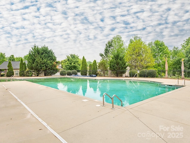 pool with fence and a patio area