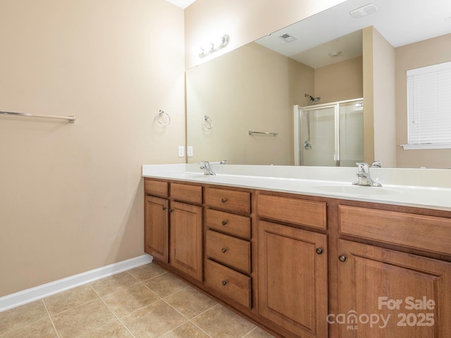 bathroom featuring tile patterned floors, a shower stall, double vanity, a sink, and visible vents