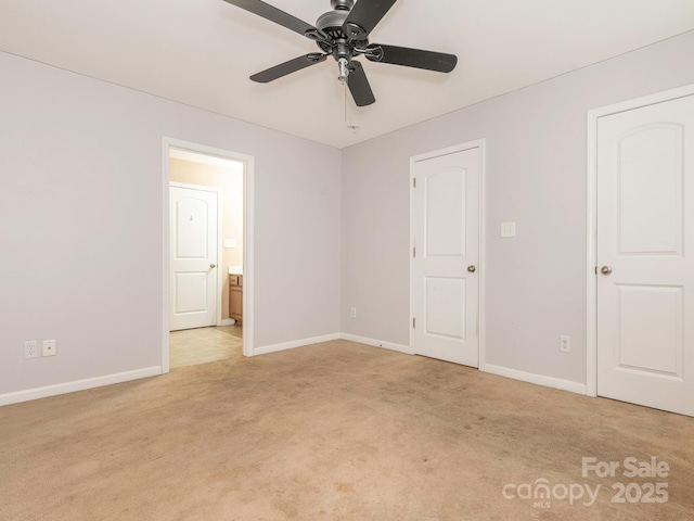 unfurnished bedroom featuring ensuite bathroom, light carpet, and baseboards