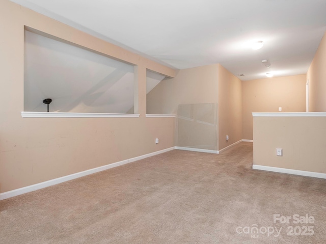 carpeted spare room with baseboards