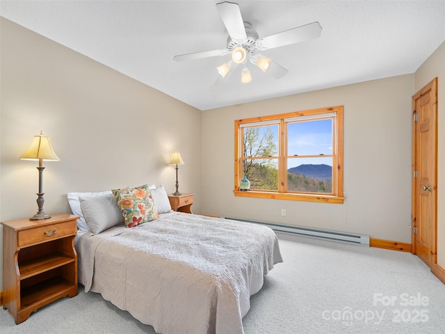 bedroom with a baseboard heating unit, ceiling fan, baseboards, and light carpet