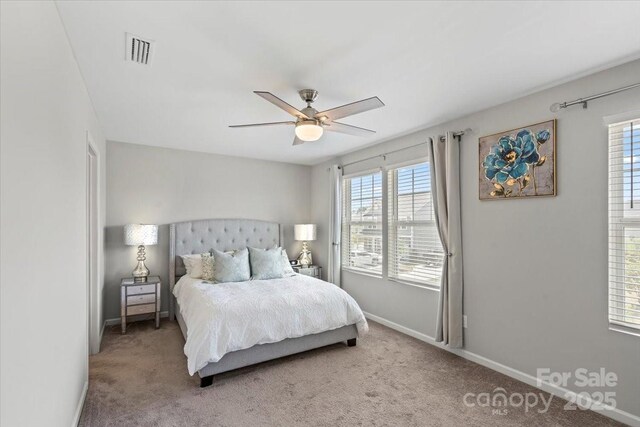 bedroom with carpet floors, multiple windows, and visible vents